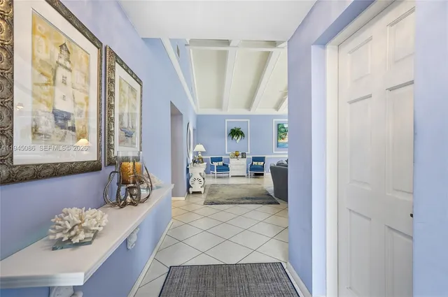 a dining room with furniture and large windows