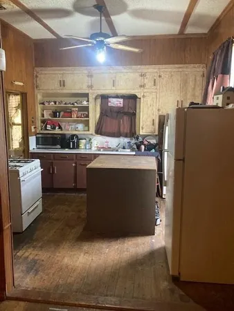 a kitchen with stainless steel appliances granite countertop a refrigerator a stove and a sink