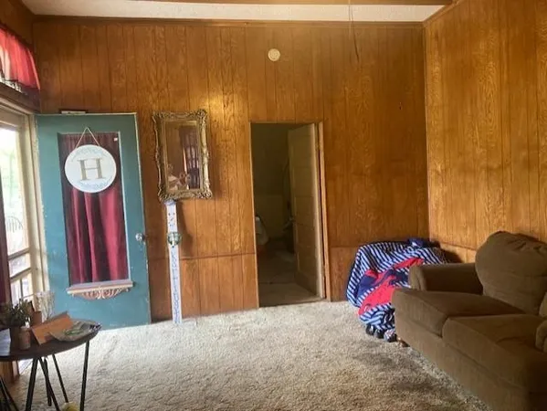 a view of a livingroom with furniture and entryway