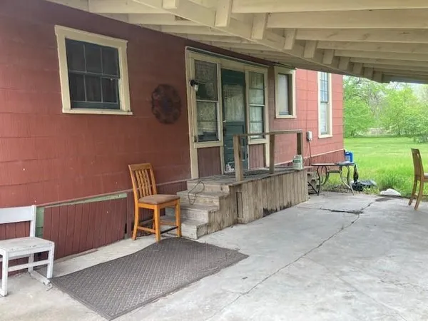 a view of a chair and table in the patio