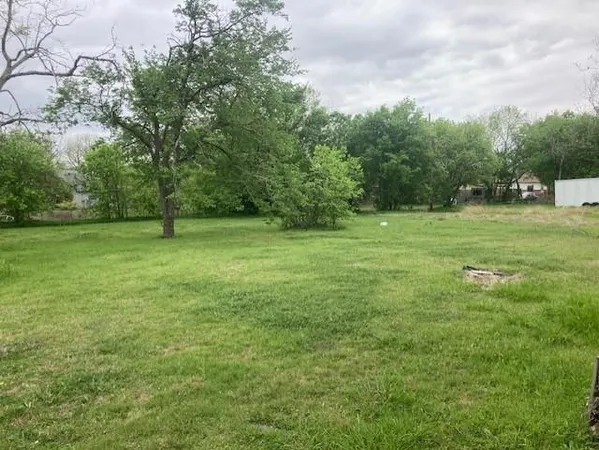 a view of outdoor space with green field and trees all around