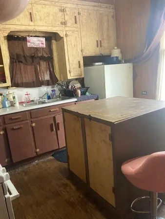 a kitchen with a sink a stove and cabinets