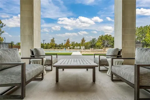 a view of a patio with table and chairs