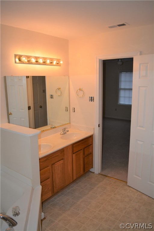 5437 Hackney Road Richmond, VA 23234 - Photo 34 of 50 a spacious bathroom with a granite countertop sink and a mirror