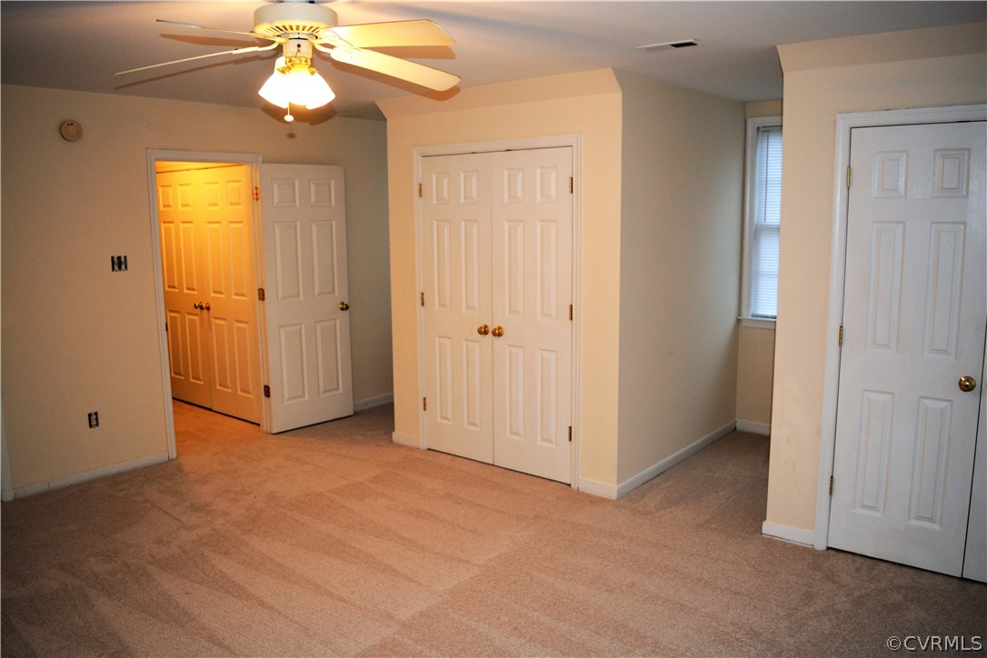 5437 Hackney Road Richmond, VA 23234 - Photo 44 of 50 an empty room with closet and a chandelier fan