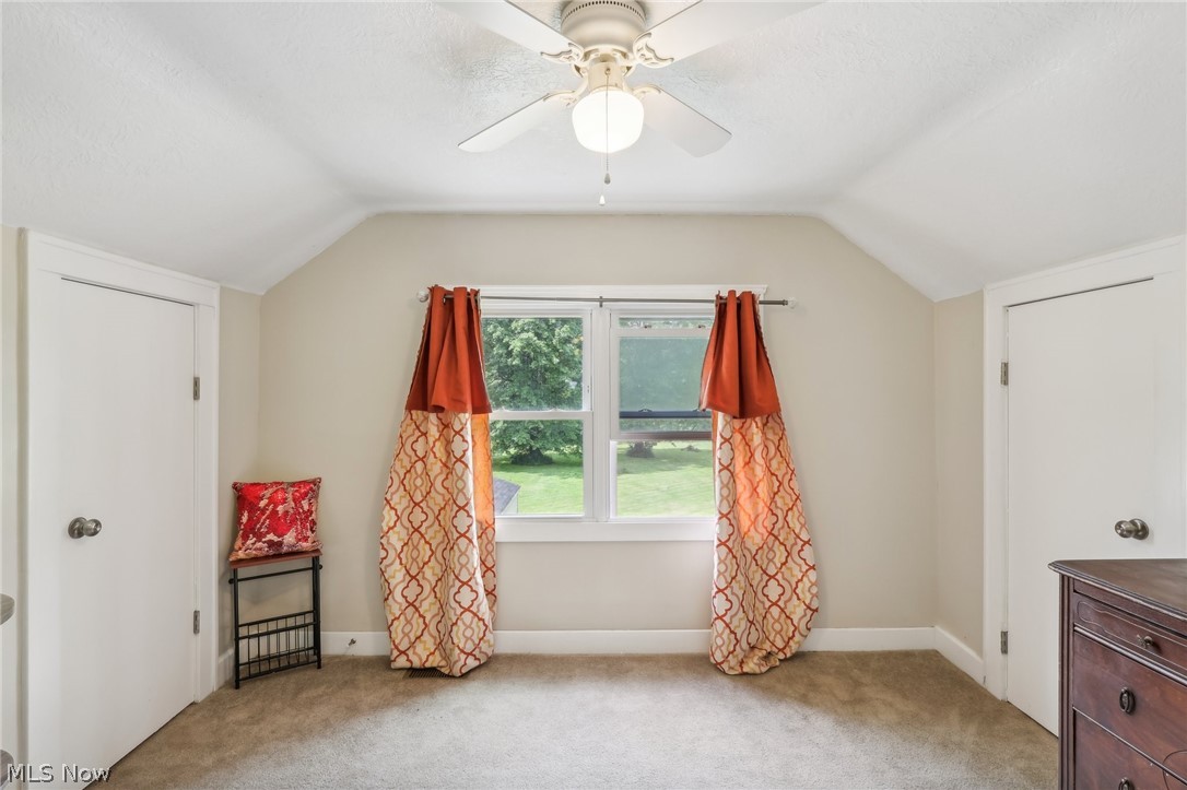 2998 Massillon Road Akron, OH 44312 - Photo 18 of 36 Bedroom with ceiling fan, vaulted ceiling, and light colored carpet
