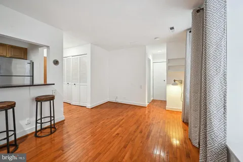 a view of empty room with wooden floor