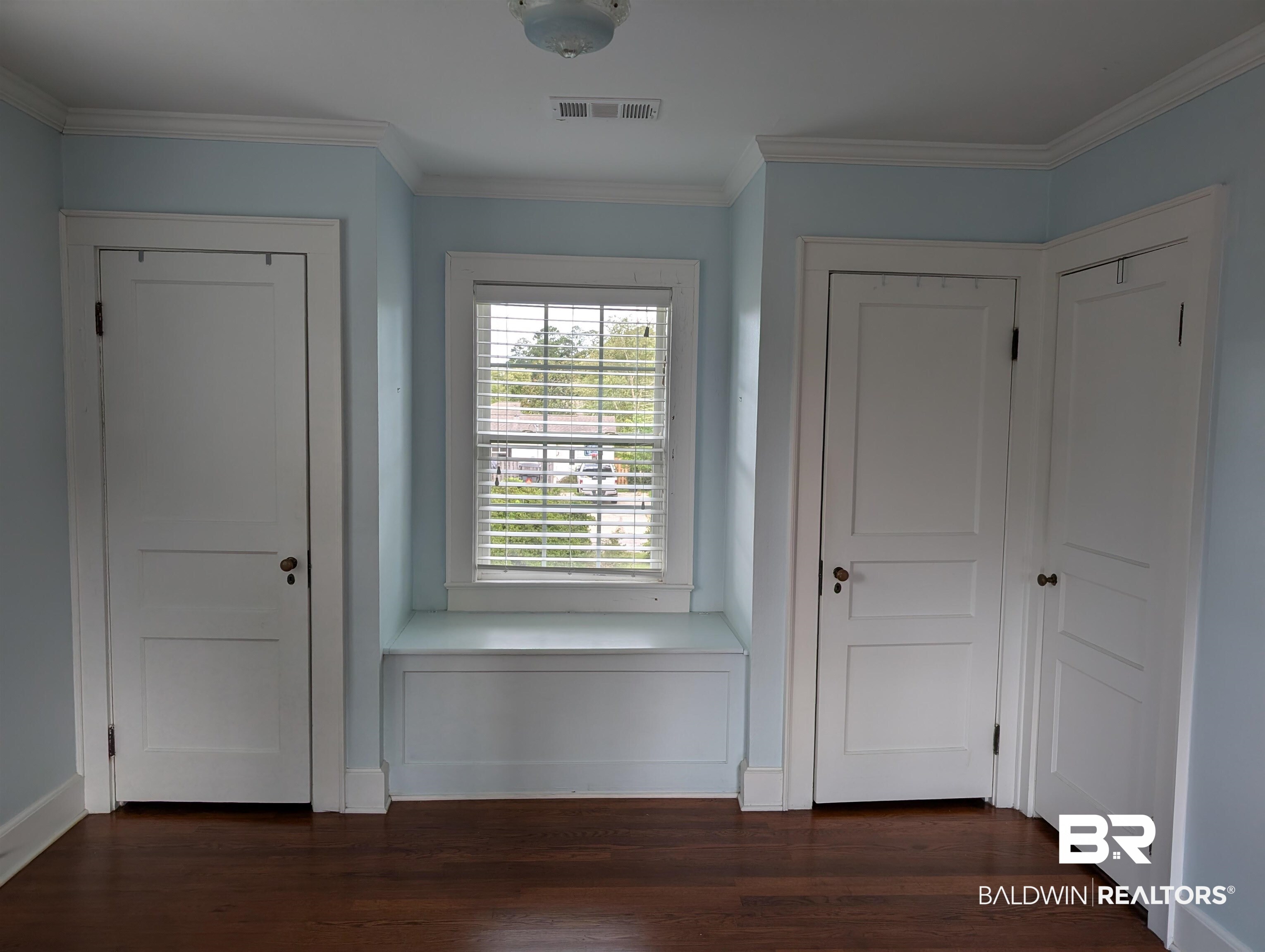 1405 Escambia Avenue Brewton, AL 36426 - Photo 12 of 16 Foyer with crown molding and dark wood-style floors