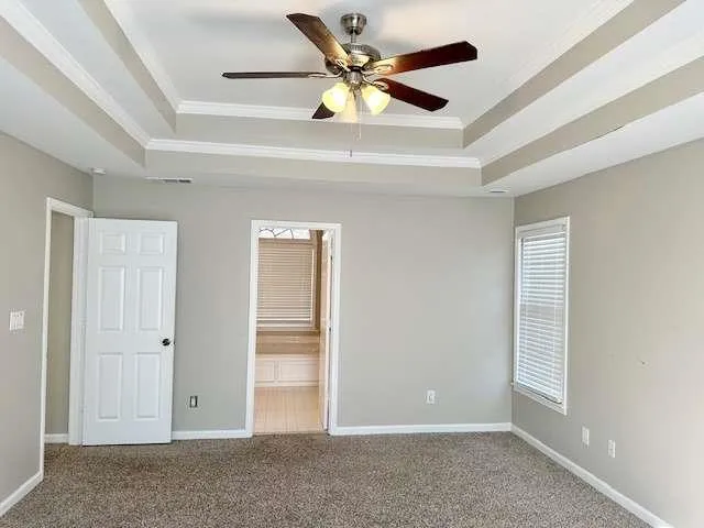 an empty room with closet and a ceiling fan