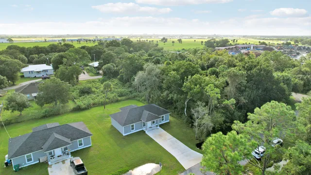 an aerial view of a house with yard swimming pool and outdoor seating
