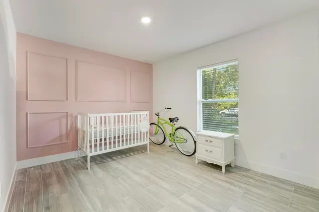 a view of a room with wooden floor and windows