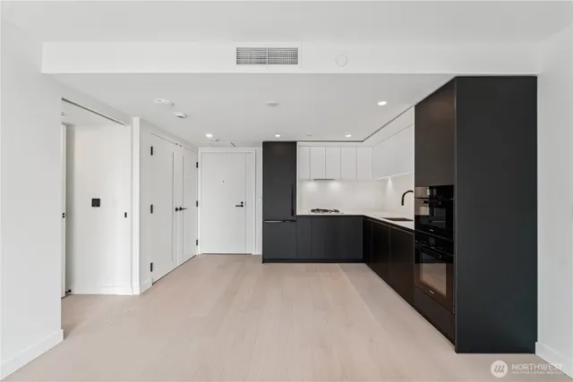 a kitchen with a refrigerator and a sink