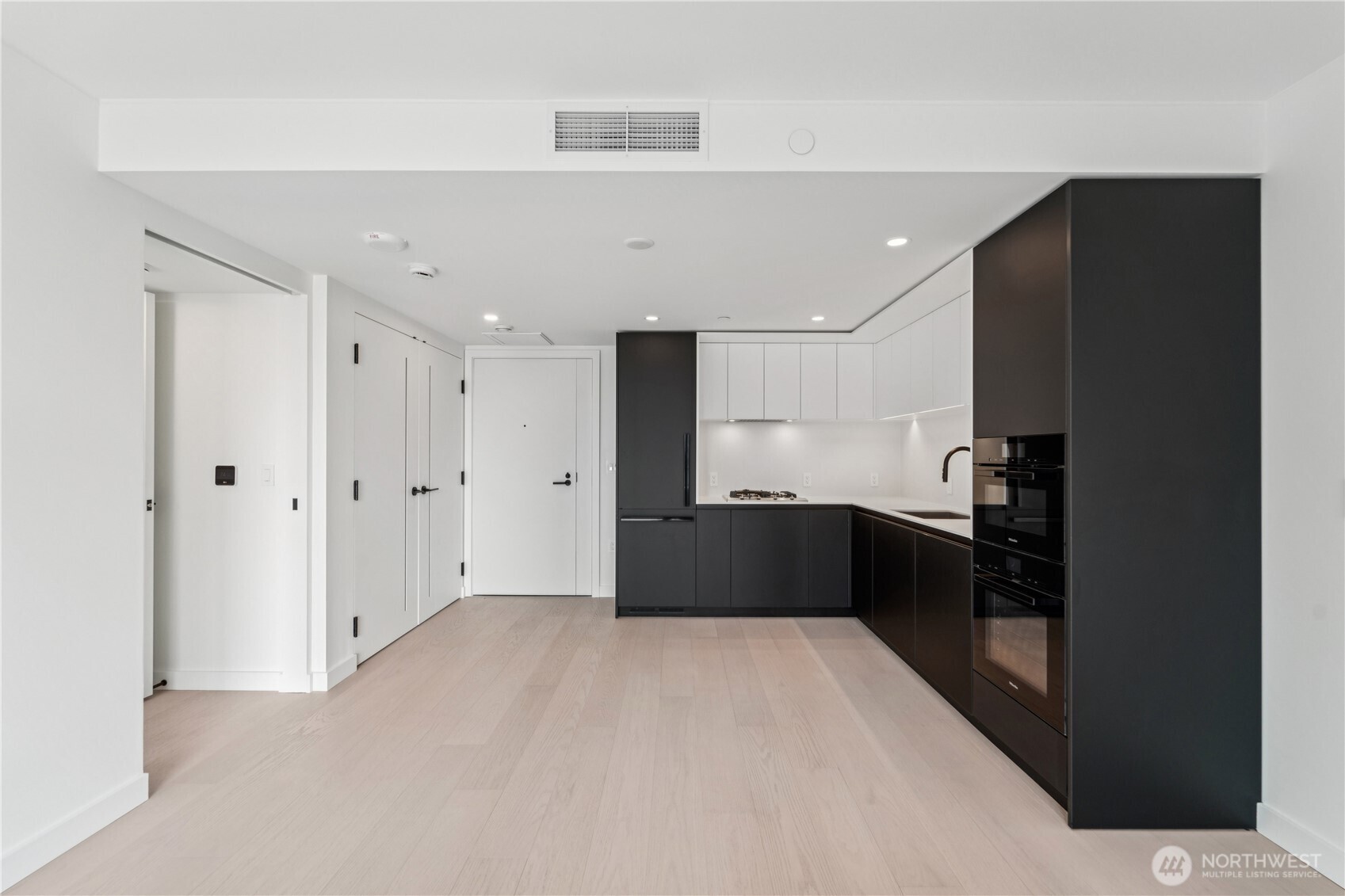 300 Virginia Street, Unit 1411 Seattle, WA 98121 - Photo 13 of 38 a kitchen with a refrigerator and a sink