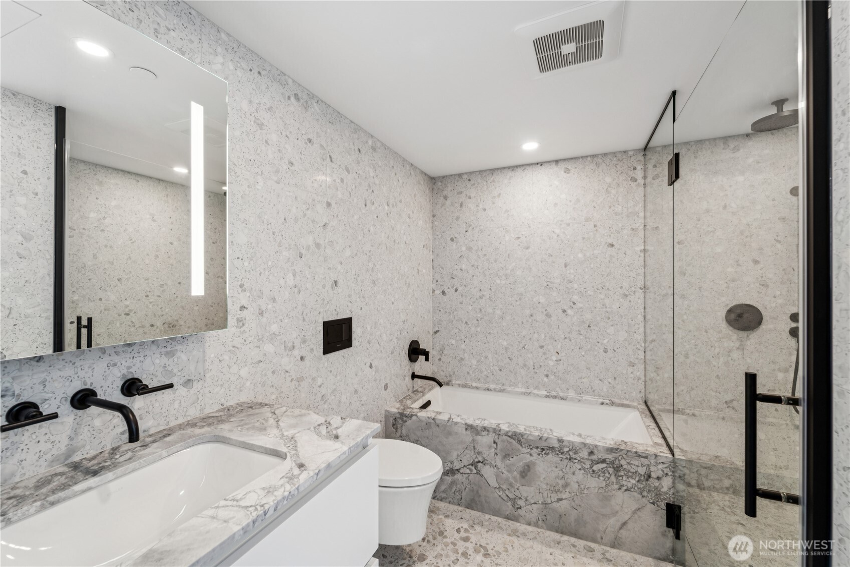 300 Virginia Street, Unit 1411 Seattle, WA 98121 - Photo 15 of 38 a bathroom with a sink toilet and shower