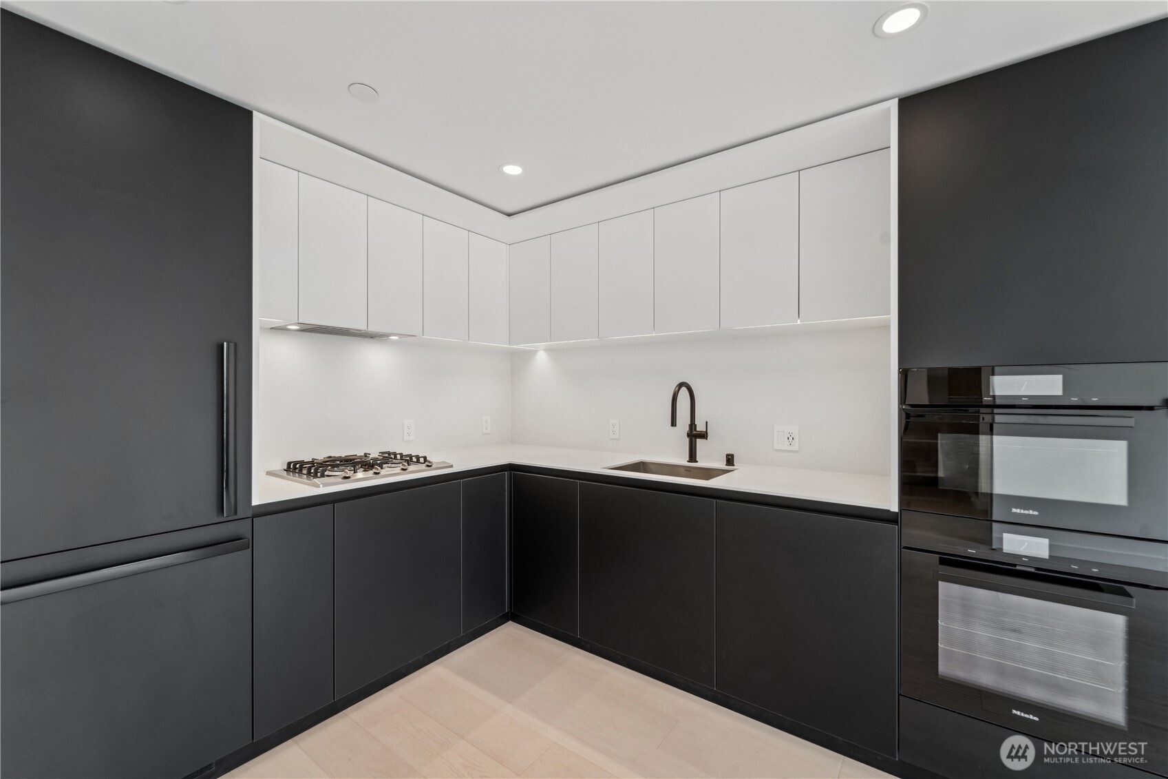 300 Virginia Street, Unit 1411 Seattle, WA 98121 - Photo 2 of 38 a kitchen with a sink and cabinets