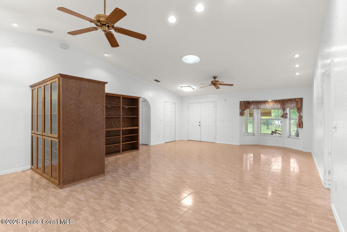 2493 Adamson Road Cocoa, FL 32926 - Photo 19 of 46 a view of empty room with wooden floor and ceiling fan
