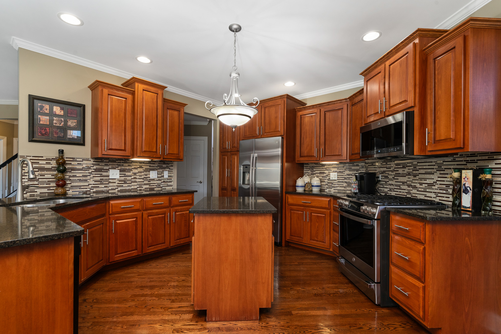 17621 Harper Road Tinley Park, IL 60487 - Photo 11 of 67 a kitchen with stainless steel appliances granite countertop wooden cabinets a stove a sink and dishwasher a oven with wooden floor