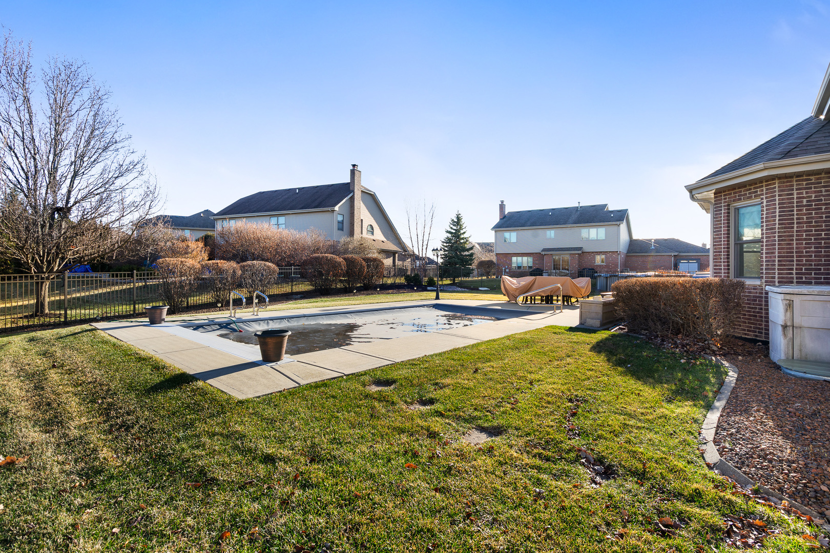 17621 Harper Road Tinley Park, IL 60487 - Photo 50 of 67 a swimming pool with some trees in the background