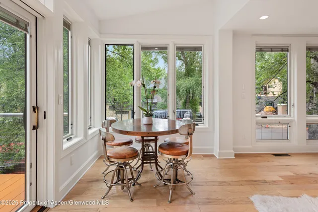a living room with furniture kitchen view and a large window