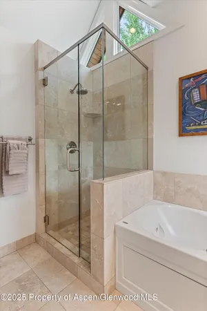 a bedroom with two beds and painting on the wall