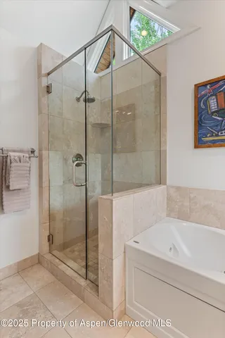 a bedroom with two beds and painting on the wall