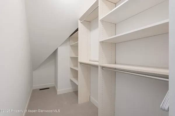 a bedroom with a bed and painting on the wall