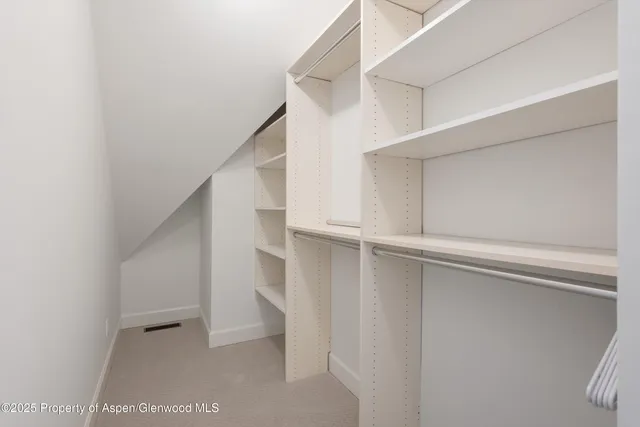 a bedroom with a bed and painting on the wall