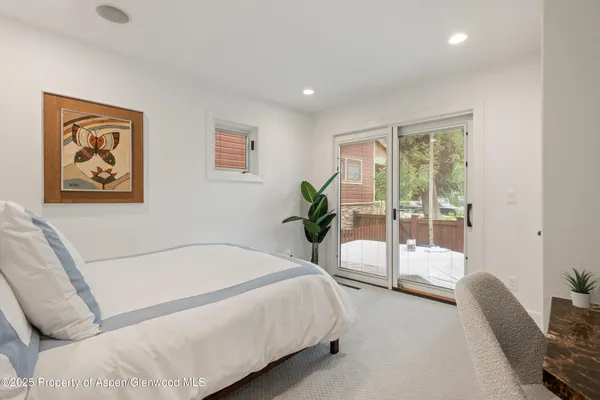 a view of a livingroom with furniture and a flat screen tv
