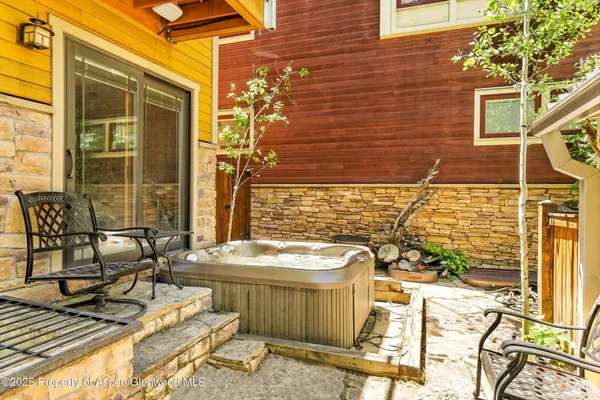 a bathroom with a tub a sink and mirror
