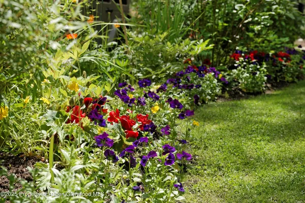 an aerial view of a house with yard outdoor seating and green space
