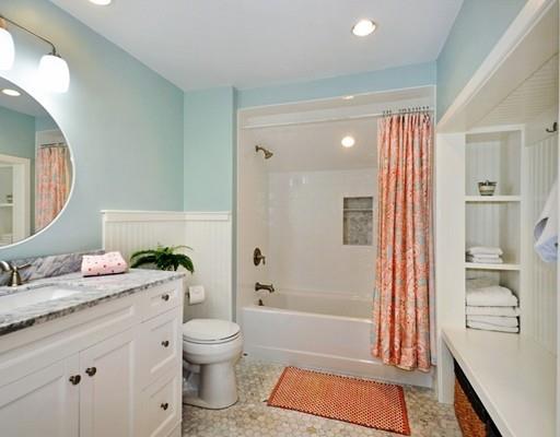8 Edmonds Road Concord, MA 01742 - Photo 13 of 36 a bathroom with a granite countertop sink toilet a mirror and shower