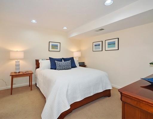 8 Edmonds Road Concord, MA 01742 - Photo 19 of 36 a bedroom with a bed and a lamp on dresser