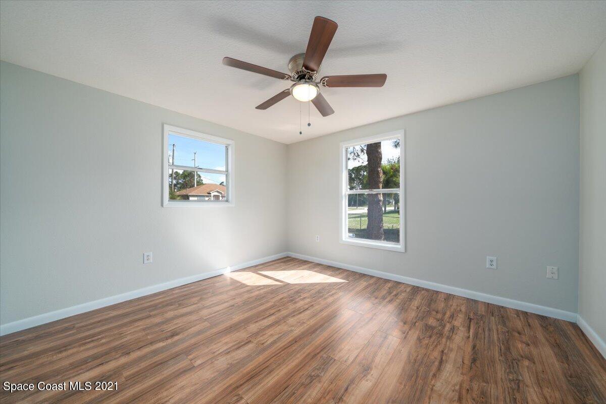 401 Tilhal Road Southwest Palm Bay, FL 32908 - Photo 14 of 26 a view of an empty room with wooden floor and a window