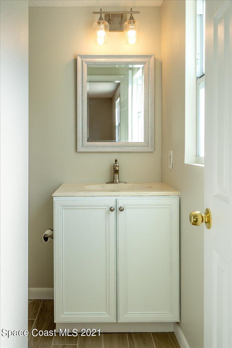 401 Tilhal Road Southwest Palm Bay, FL 32908 - Photo 22 of 26 a bathroom with a sink and a mirror