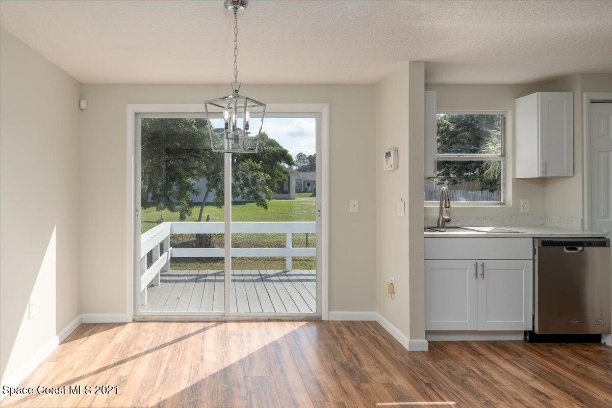 401 Tilhal Road Southwest Palm Bay, FL 32908 - Photo 8 of 26 a view of a kitchen with wooden floor and a sink