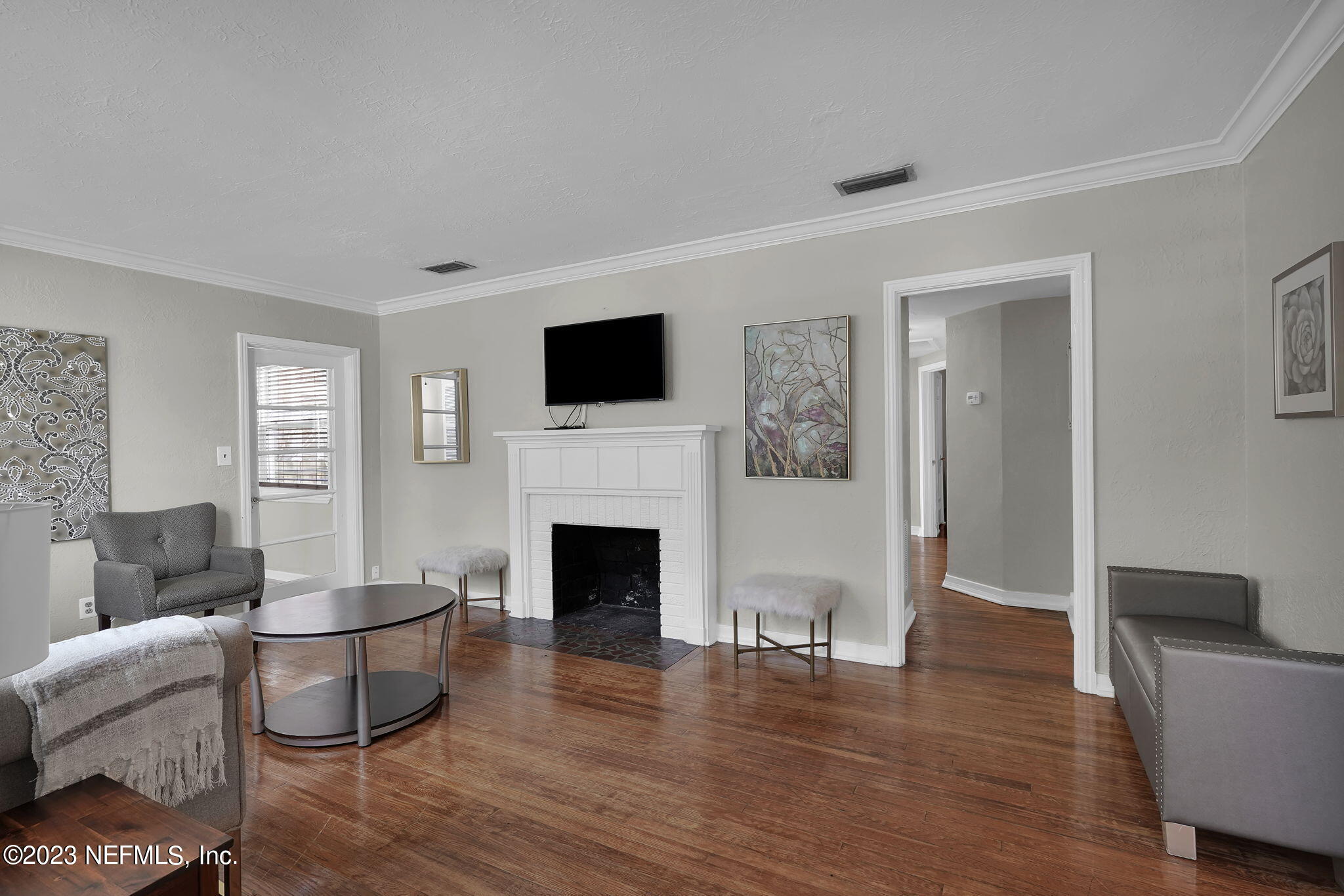 a living room with furniture and a fireplace