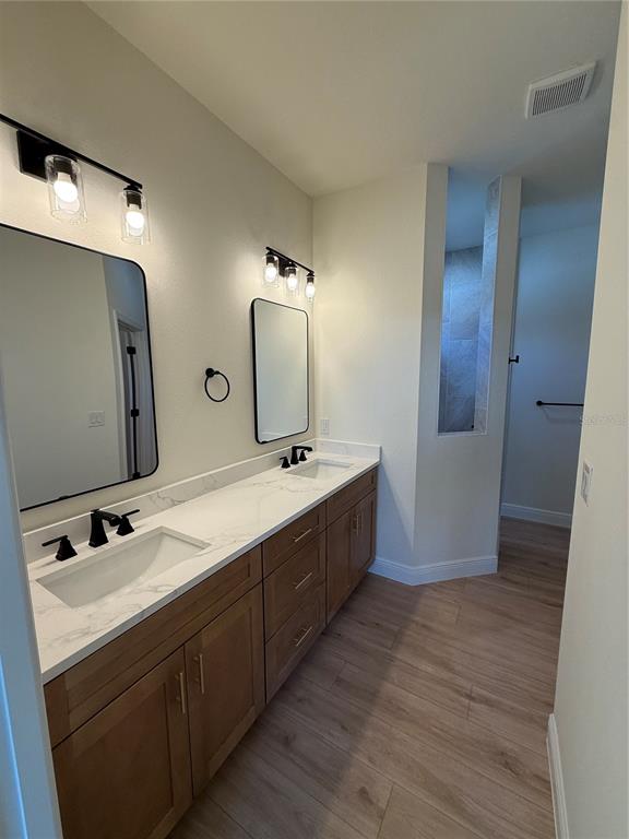 26275 Explorer Road Punta Gorda, FL 33983 - Photo 11 of 22 a bathroom with a double vanity sink and mirror