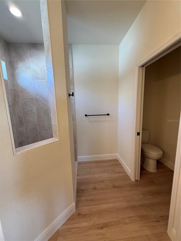 26275 Explorer Road Punta Gorda, FL 33983 - Photo 15 of 22 a view of a hallway with wooden floor and a bathroom