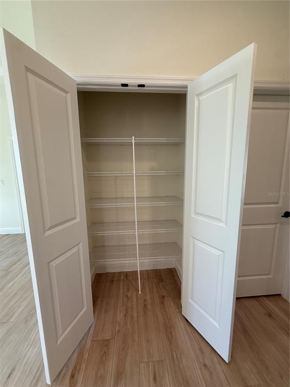 26275 Explorer Road Punta Gorda, FL 33983 - Photo 19 of 22 a room with walk in closet and wooden floor