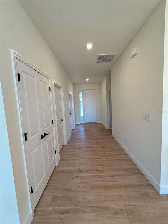26275 Explorer Road Punta Gorda, FL 33983 - Photo 4 of 22 a view of a hallway with wooden floor