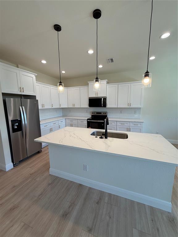 26275 Explorer Road Punta Gorda, FL 33983 - Photo 5 of 22 a kitchen with kitchen island a counter space a sink appliances and cabinets