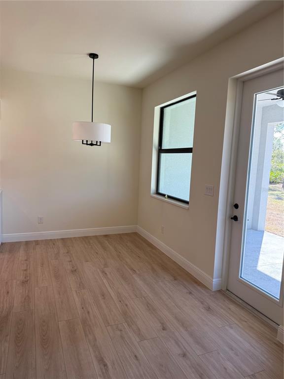 26275 Explorer Road Punta Gorda, FL 33983 - Photo 8 of 22 a view of empty room with wooden floor and fan
