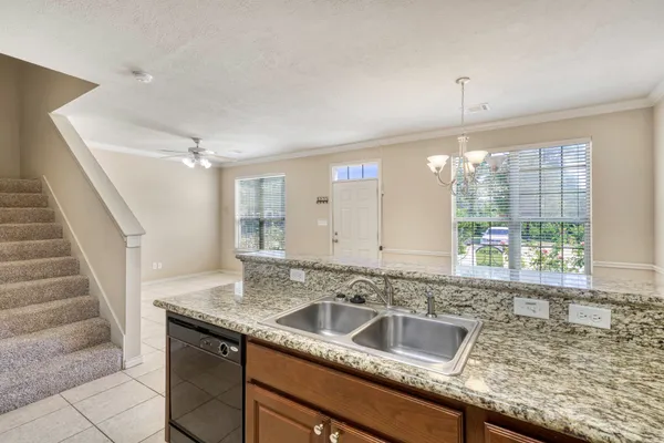 a view with granite countertop a sink and a window