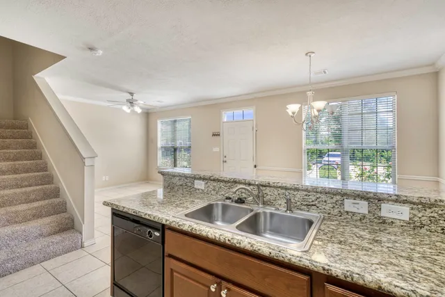 a view with granite countertop a sink and a window