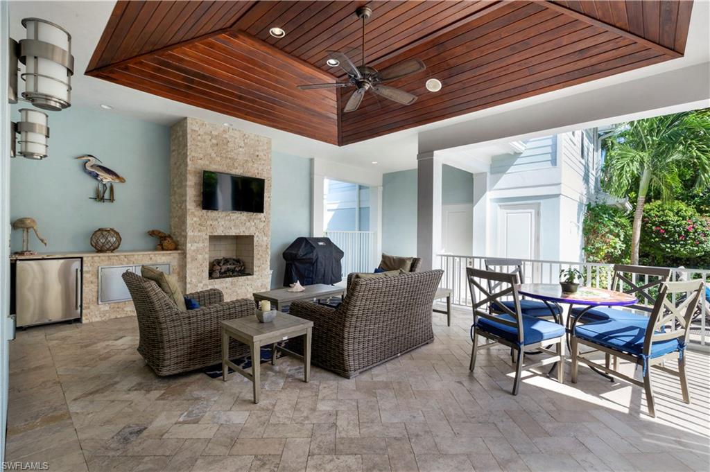 150 Central Avenue Naples, FL 34102 - Photo 22 of 34 a living room with furniture a fireplace and a table