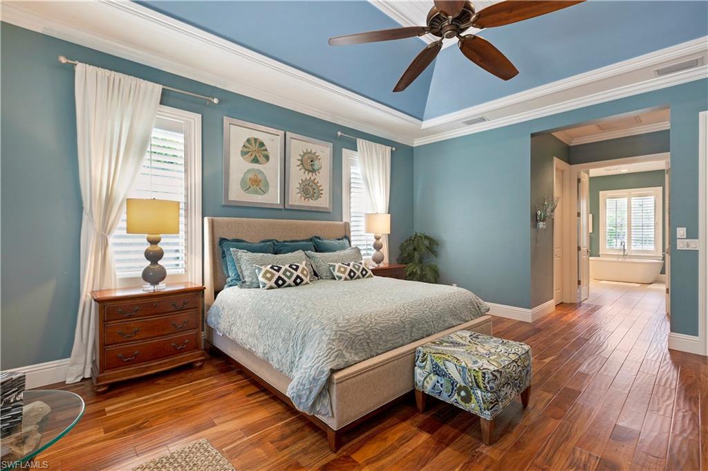 150 Central Avenue Naples, FL 34102 - Photo 10 of 34 a bedroom with a bed mirror and a window