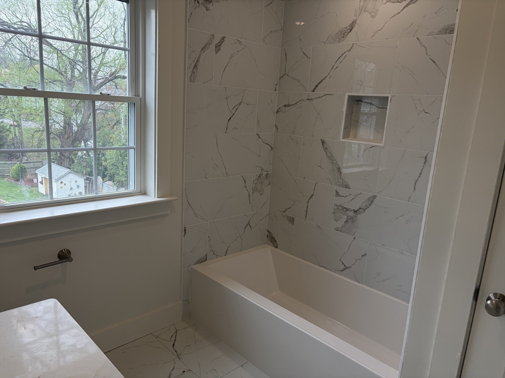76 Valmor Street Worcester, MA 01604 - Photo 16 of 20 a bath tub sitting next to a window