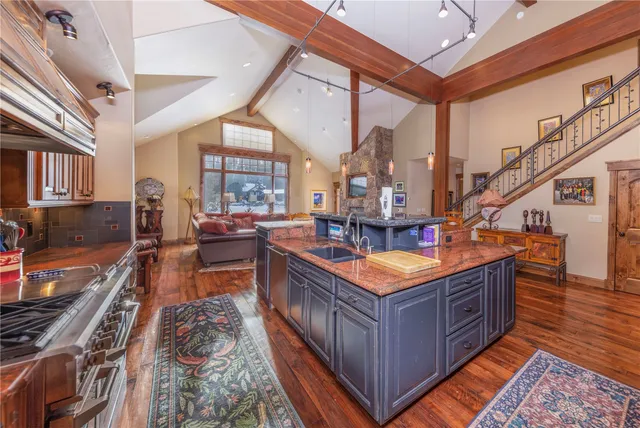 a dining hall with stainless steel appliances granite countertop a stove and a large window