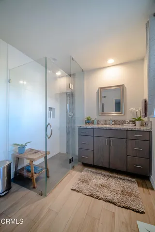 a bathroom with a granite countertop sink mirror and toilet