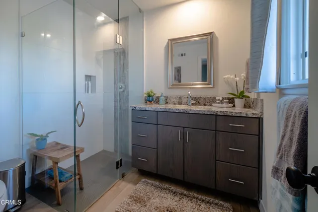 a bathroom with a double vanity sink and mirror